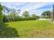 Large grassy backyard with lush landscaping and privacy hedge at 13207 49Th E Ln, Parrish, FL 34219