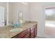 Bathroom with granite countertop, single sink, and access to backyard at 13207 49Th E Ln, Parrish, FL 34219