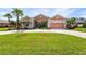 Beautiful one-story home with a large front yard and palm trees at 13207 49Th E Ln, Parrish, FL 34219