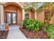 Double front doors with decorative glass, flanked by lush landscaping at 13207 49Th E Ln, Parrish, FL 34219