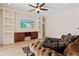 Spacious living room featuring built-in shelving and a large TV at 13207 49Th E Ln, Parrish, FL 34219