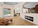 Bright living room with fireplace and view into kitchen and pool area at 13207 49Th E Ln, Parrish, FL 34219
