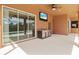 Covered patio features an outdoor kitchen with stainless steel appliances and a large TV at 13207 49Th E Ln, Parrish, FL 34219