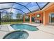 Relaxing screened pool and spa with outdoor kitchen at 13207 49Th E Ln, Parrish, FL 34219
