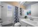 Clean bathroom with white vanity, shower/tub combo and blue accents at 14721 Bowfin Ter, Lakewood Ranch, FL 34202