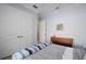 bedroom with a full-size bed and built in shelves at 14721 Bowfin Ter, Lakewood Ranch, FL 34202