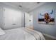 Guest bedroom with a full-size bed and double doors to hallway at 14721 Bowfin Ter, Lakewood Ranch, FL 34202