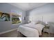 Cozy bedroom with a queen-size bed and light wood floors at 14721 Bowfin Ter, Lakewood Ranch, FL 34202
