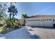 Inviting home exterior featuring a three-car garage and lush landscaping at 14721 Bowfin Ter, Lakewood Ranch, FL 34202