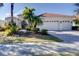 White two-story house with a three-car garage and lush landscaping at 14721 Bowfin Ter, Lakewood Ranch, FL 34202