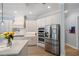 Modern kitchen with stainless steel appliances and white cabinetry at 14721 Bowfin Ter, Lakewood Ranch, FL 34202