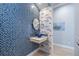 Stylish powder room, blue mosaic tile, vessel sink, and nautical wallpaper at 14721 Bowfin Ter, Lakewood Ranch, FL 34202