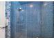 Spa-like shower with blue mosaic tile and glass enclosure at 14721 Bowfin Ter, Lakewood Ranch, FL 34202