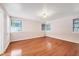 Spacious bedroom with hardwood floors and multiple windows at 1509 Flower Dr, Sarasota, FL 34239