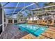 Inviting swimming pool with screened enclosure at 1509 Flower Dr, Sarasota, FL 34239