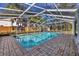 Relaxing screened pool with brick patio at 1509 Flower Dr, Sarasota, FL 34239