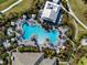 Aerial view of a luxury community pool with surrounding amenities and lush landscaping at 15610 San Lazzaro Ave, Bradenton, FL 34211
