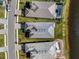 Aerial view of homes with dark tiled roofs, manicured lawns, and waterfront community at 15610 San Lazzaro Ave, Bradenton, FL 34211