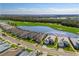 An aerial view showcasing the beautiful golf course and lake community, surrounded by lush greenery and well-kept lawns at 15610 San Lazzaro Ave, Bradenton, FL 34211