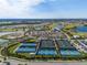 Aerial view of the community featuring tennis courts, lakes, and well-maintained landscaping at 15610 San Lazzaro Ave, Bradenton, FL 34211