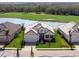 Gorgeous aerial view of a lakeside house surrounded by mature landscaping and a lush golf course at 15610 San Lazzaro Ave, Bradenton, FL 34211