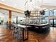 Upscale community bar area with stylish seating, herringbone floors, and multiple televisions at 15610 San Lazzaro Ave, Bradenton, FL 34211