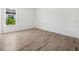 Bright bedroom with tile flooring and a large window overlooking lush landscaping at 15610 San Lazzaro Ave, Bradenton, FL 34211