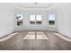 Unfurnished bedroom with three large windows offering a serene lake view at 15610 San Lazzaro Ave, Bradenton, FL 34211