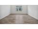 Bright bedroom featuring sleek, modern wood-look tile flooring and a large window at 15610 San Lazzaro Ave, Bradenton, FL 34211