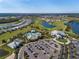 Aerial view of an amenity center, showcasing a pool, golf course, and other community features at 15610 San Lazzaro Ave, Bradenton, FL 34211