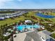 Aerial view of the community pool area featuring comfortable seating areas, lush landscaping, and a resort-style pool at 15610 San Lazzaro Ave, Bradenton, FL 34211