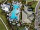 Aerial shot of the community pool highlighting umbrellas, lounge chairs, and a uniquely shaped pool at 15610 San Lazzaro Ave, Bradenton, FL 34211
