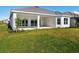 Back exterior of home with a covered patio and sliding glass doors, perfect for enjoying outdoor living at 15610 San Lazzaro Ave, Bradenton, FL 34211