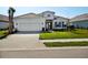 A beautiful home with a two-car garage and a brick-paved driveway at 15610 San Lazzaro Ave, Bradenton, FL 34211