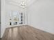 Bright foyer with chandelier, white walls, and wood-look tile flooring welcomes you into this lovely home at 15610 San Lazzaro Ave, Bradenton, FL 34211
