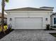 A two-car garage with a brick-paved driveway and landscaped yard at 15610 San Lazzaro Ave, Bradenton, FL 34211
