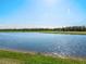 Scenic view of a lake bordering a lush green golf course on a sunny day at 15610 San Lazzaro Ave, Bradenton, FL 34211