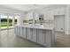 Modern eat-in kitchen with white countertops, stainless steel appliances, and a large center island at 15610 San Lazzaro Ave, Bradenton, FL 34211