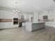 Spacious kitchen with white cabinetry, stainless steel appliances, and large center island at 15610 San Lazzaro Ave, Bradenton, FL 34211