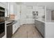 Spacious kitchen showcases an island, stainless steel appliances, and wood-look tile flooring at 15610 San Lazzaro Ave, Bradenton, FL 34211