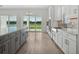 Open kitchen boasts an island and a view through sliding glass doors to the water at 15610 San Lazzaro Ave, Bradenton, FL 34211
