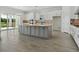 Modern eat-in kitchen with stainless steel appliances, a large island, and views of the backyard at 15610 San Lazzaro Ave, Bradenton, FL 34211