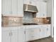 Modern kitchen features stainless steel appliances, stylish backsplash, and shaker style cabinets at 15610 San Lazzaro Ave, Bradenton, FL 34211
