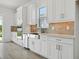 Modern kitchen with white cabinets, stainless steel appliances, and bright counter space at 15610 San Lazzaro Ave, Bradenton, FL 34211