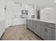 Kitchen features a large island, white upper cabinets and gray lower cabinets at 15610 San Lazzaro Ave, Bradenton, FL 34211
