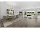 Open-concept living and dining area with views of the lanai and pond beyond at 15610 San Lazzaro Ave, Bradenton, FL 34211