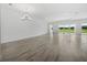 Open-concept living area with light wood-look tile flooring and large windows at 15610 San Lazzaro Ave, Bradenton, FL 34211