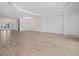 Spacious living room with tray ceiling, recessed lighting, and wood-look tile flooring at 15610 San Lazzaro Ave, Bradenton, FL 34211
