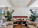Modern community lounge with a decorative fireplace, stylish seating, and elegant light fixtures at 15610 San Lazzaro Ave, Bradenton, FL 34211