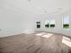 Unfurnished main bedroom with tray ceiling, three windows, and lakeside view at 15610 San Lazzaro Ave, Bradenton, FL 34211